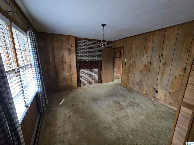 interior space with carpet floors and wooden walls