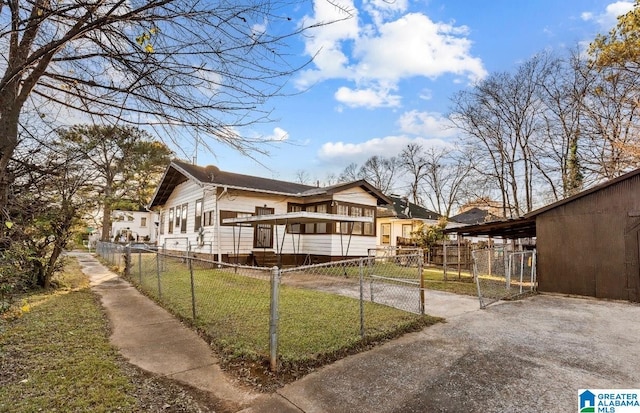 view of front of house with a front yard and a carport