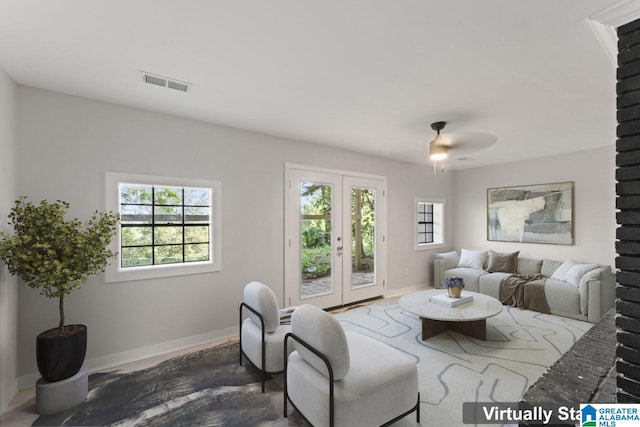 living room with ceiling fan and french doors