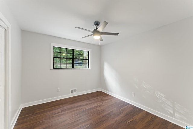 empty room featuring ceiling fan and dark hardwood / wood-style floors