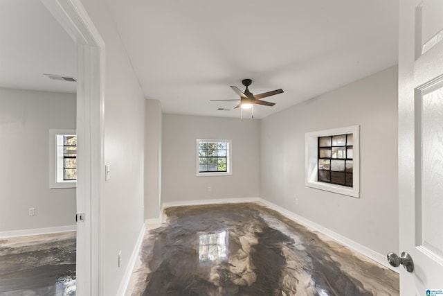 empty room featuring ceiling fan and concrete flooring