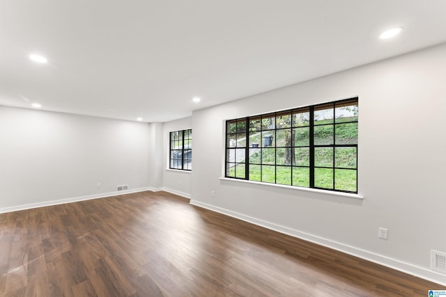 empty room with dark hardwood / wood-style floors