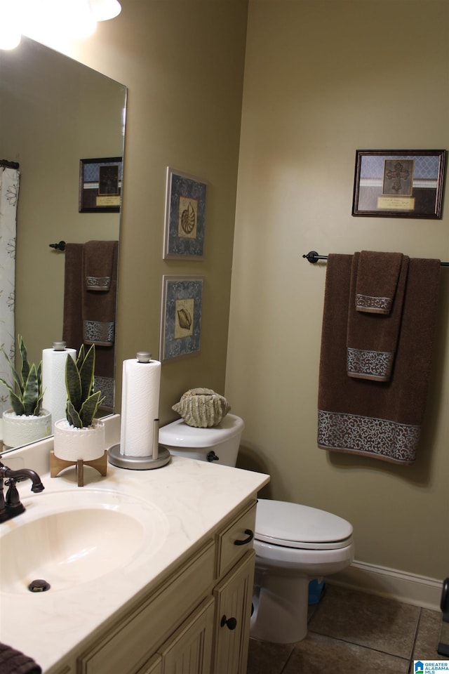 bathroom featuring vanity, tile patterned flooring, and toilet