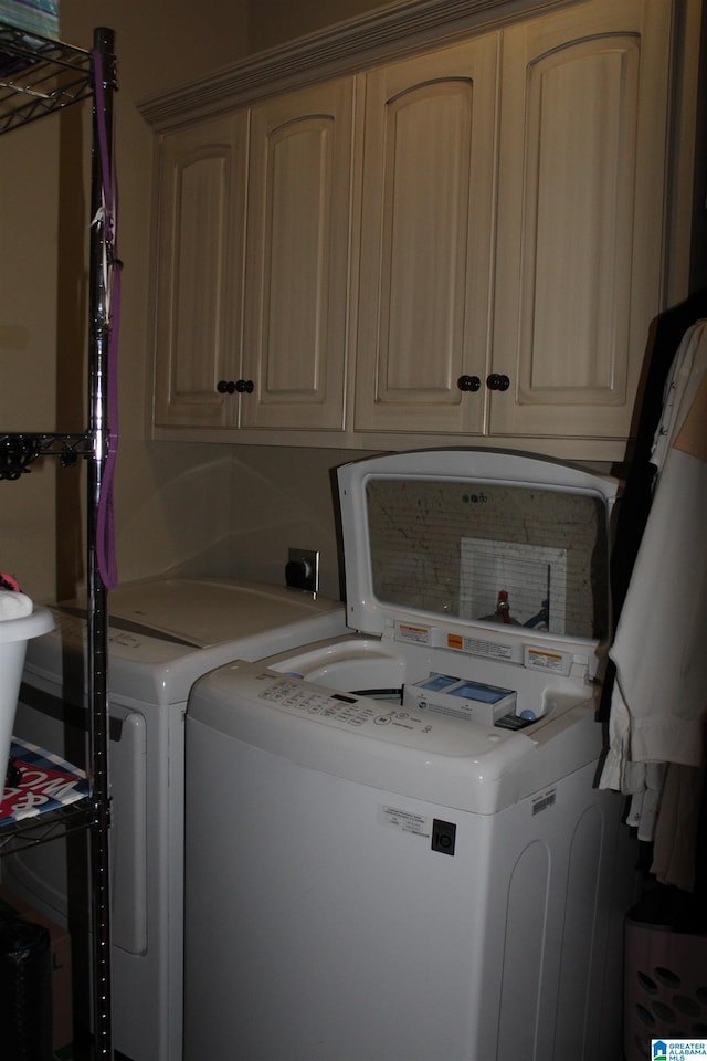 washroom with cabinets and separate washer and dryer