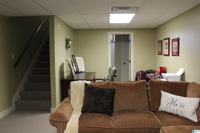 carpeted living room featuring a paneled ceiling