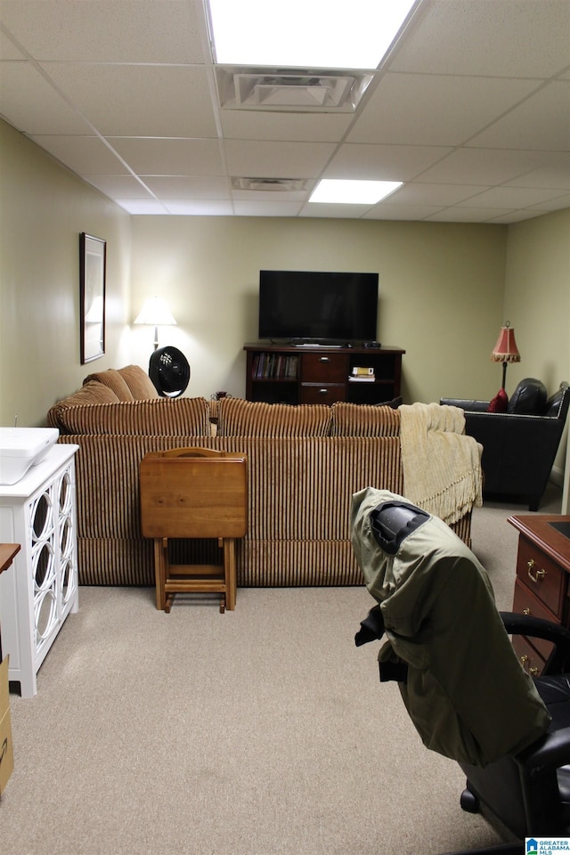 living room featuring a paneled ceiling and light colored carpet