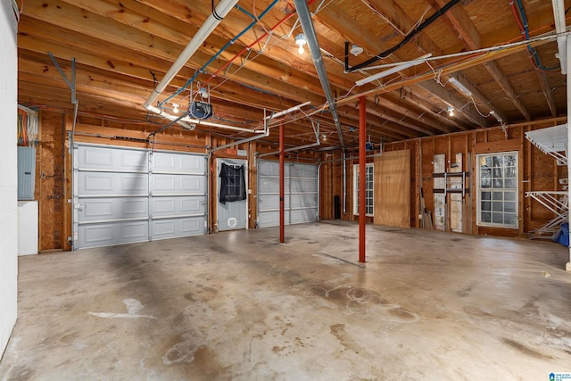 garage featuring a garage door opener and electric panel