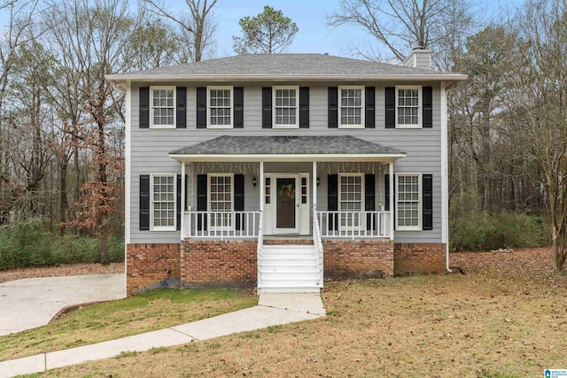 view of front of house featuring a front yard and covered porch