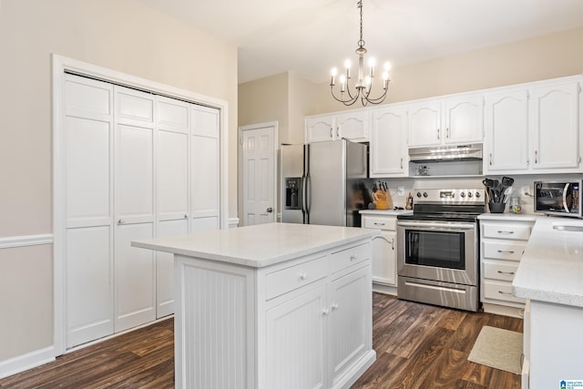 kitchen featuring white cabinetry, dark hardwood / wood-style floors, a notable chandelier, pendant lighting, and appliances with stainless steel finishes