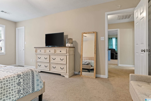 carpeted bedroom featuring a textured ceiling