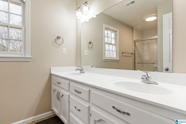 bathroom with vanity and a shower with shower door