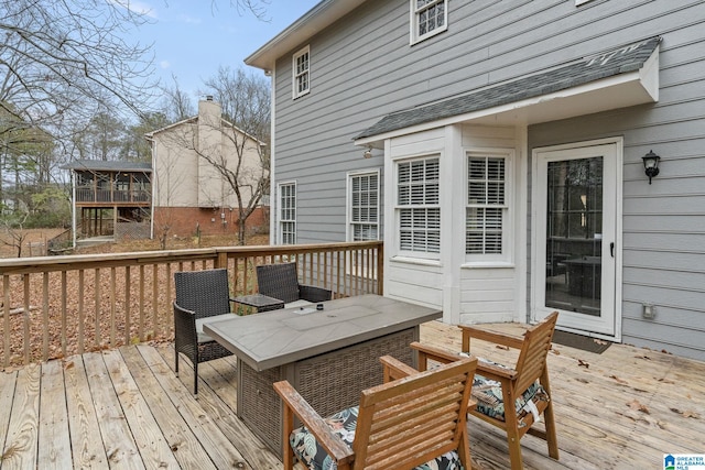 wooden deck with a sunroom