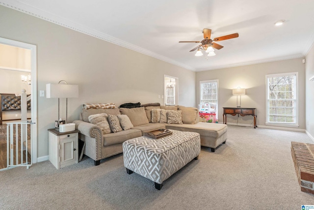 carpeted living room with ceiling fan and ornamental molding