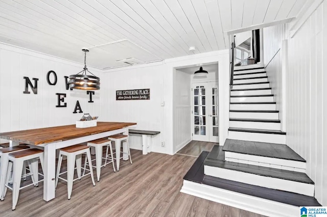 dining room featuring ornamental molding, wood ceiling, and hardwood / wood-style flooring