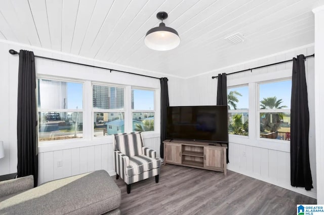 living area featuring a healthy amount of sunlight, wood-type flooring, and wood ceiling