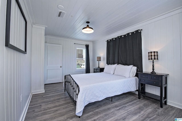 bedroom with crown molding, wooden ceiling, and dark hardwood / wood-style floors