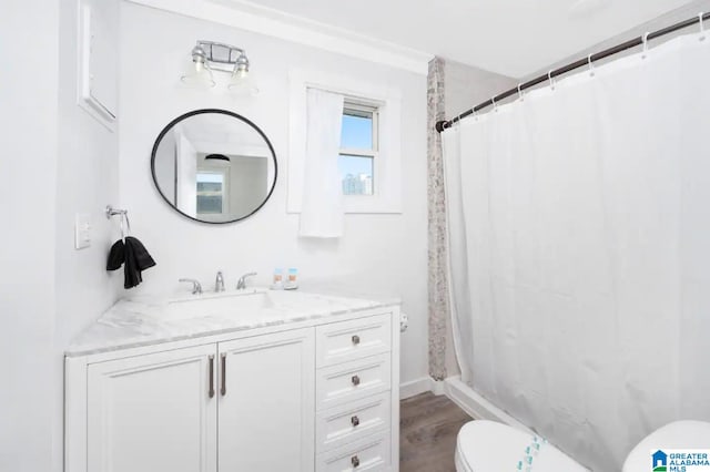 bathroom featuring vanity, hardwood / wood-style flooring, toilet, and curtained shower