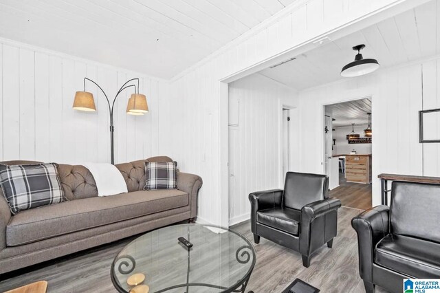 living room with hardwood / wood-style floors, wood ceiling, and ornamental molding