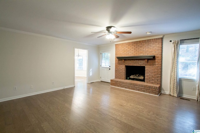 unfurnished living room featuring dark hardwood / wood-style flooring, ceiling fan, a fireplace, and ornamental molding