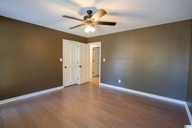 spare room featuring hardwood / wood-style floors and ceiling fan