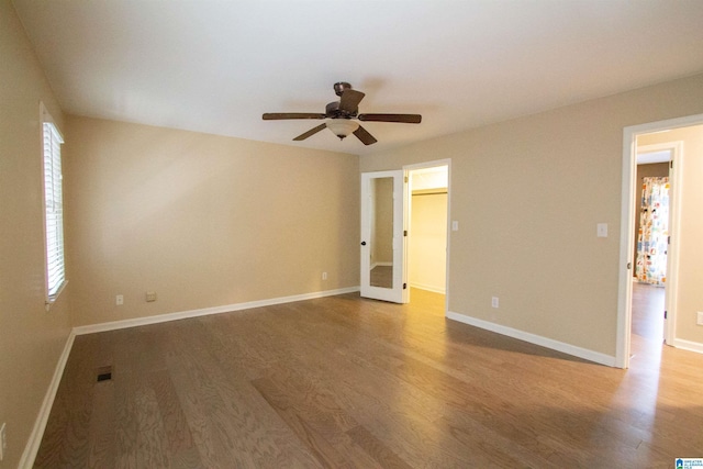 empty room featuring hardwood / wood-style flooring, plenty of natural light, and ceiling fan