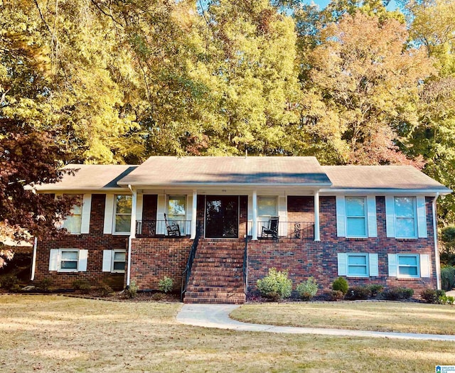 view of front of home featuring covered porch and a front yard