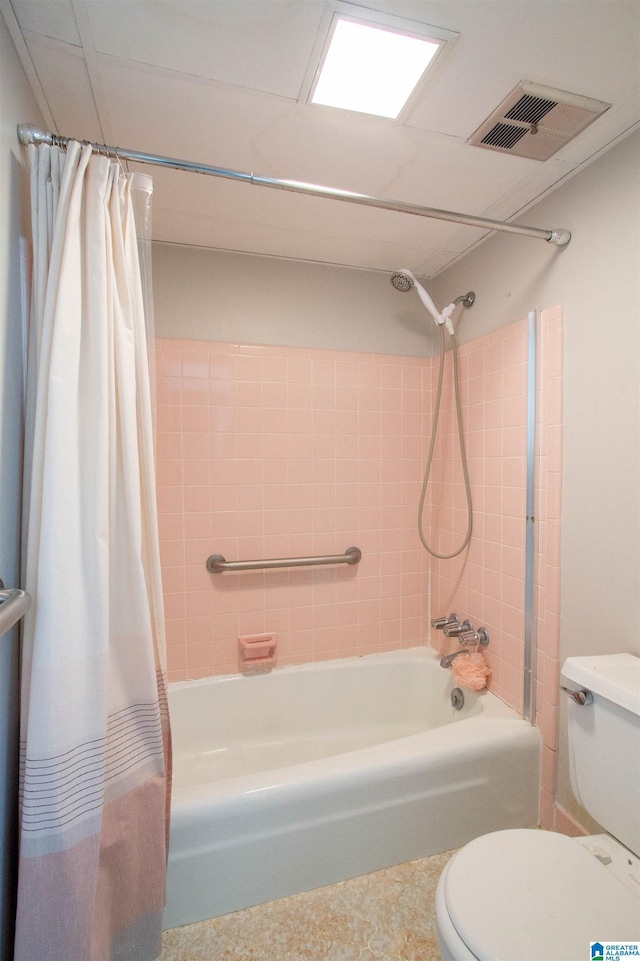 bathroom featuring shower / bath combination with curtain and toilet