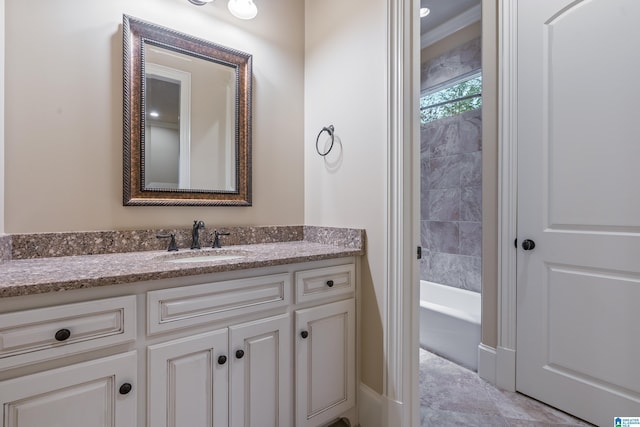 bathroom with a washtub and vanity