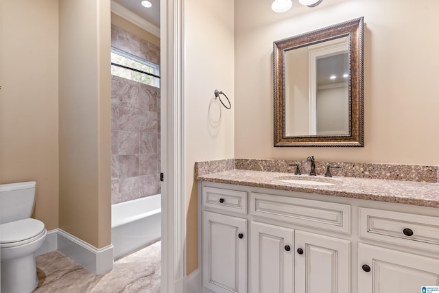 bathroom with a washtub, vanity, ornamental molding, and toilet