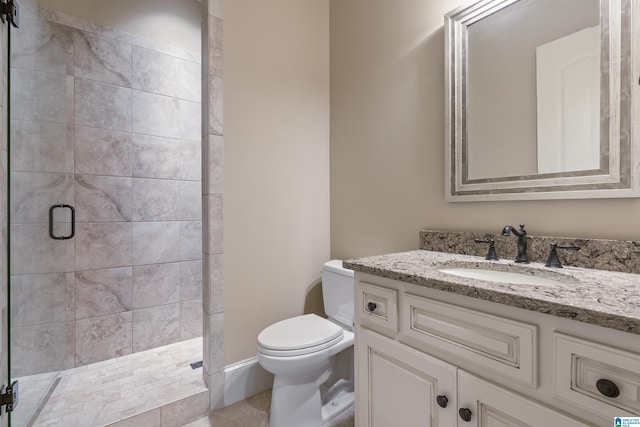 bathroom with a shower with door, vanity, and toilet