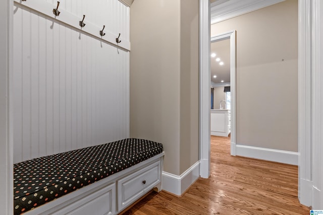 mudroom featuring light hardwood / wood-style flooring and ornamental molding