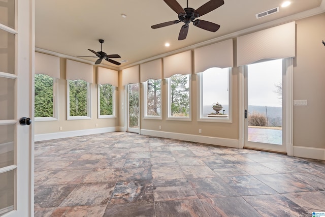 unfurnished sunroom featuring ceiling fan