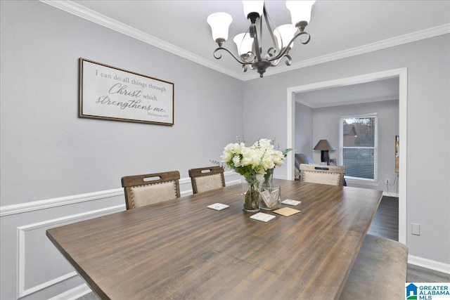 dining room featuring hardwood / wood-style flooring, crown molding, and a chandelier