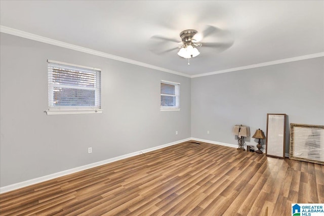 empty room featuring hardwood / wood-style floors, ceiling fan, and crown molding