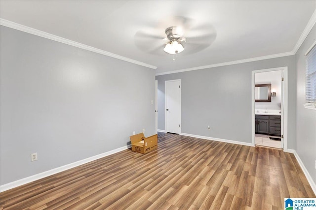 unfurnished bedroom with wood-type flooring, connected bathroom, ceiling fan, and ornamental molding