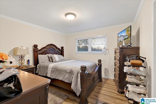 bedroom featuring light wood-type flooring and ornamental molding