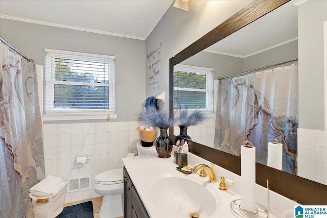 bathroom featuring vanity, crown molding, tile patterned flooring, toilet, and tile walls