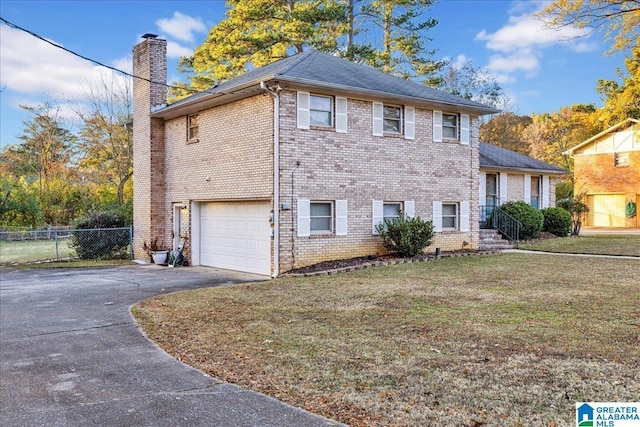 view of front of house featuring a garage and a front lawn