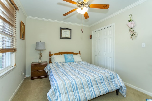 bedroom featuring ceiling fan, light colored carpet, ornamental molding, and a closet