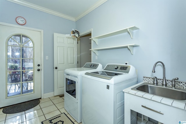 clothes washing area featuring independent washer and dryer, crown molding, light tile patterned floors, and sink