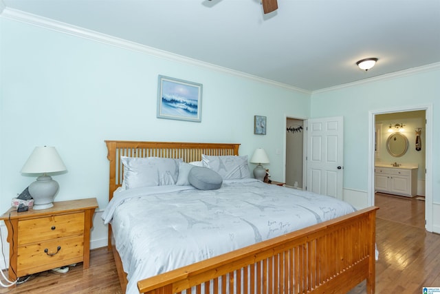 bedroom with ensuite bathroom, light hardwood / wood-style flooring, ceiling fan, and crown molding