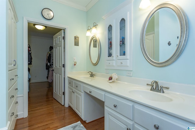 bathroom with hardwood / wood-style flooring, vanity, and crown molding