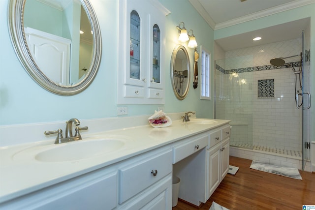 bathroom with crown molding, a shower with door, vanity, and hardwood / wood-style flooring