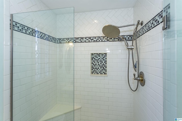 bathroom with tiled shower