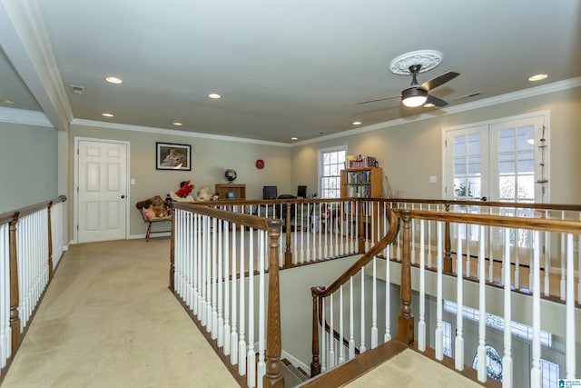 corridor with crown molding and light colored carpet