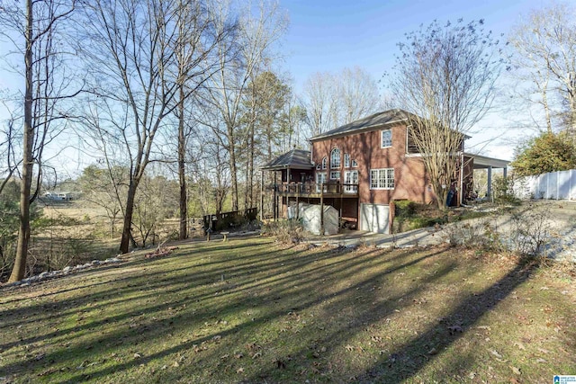 rear view of property with a yard and a wooden deck