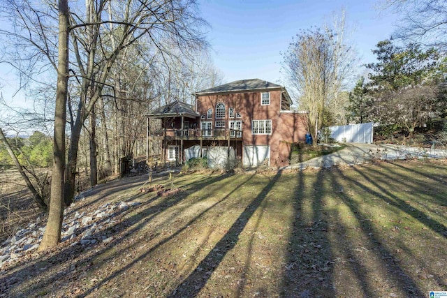 back of house with a lawn and a wooden deck