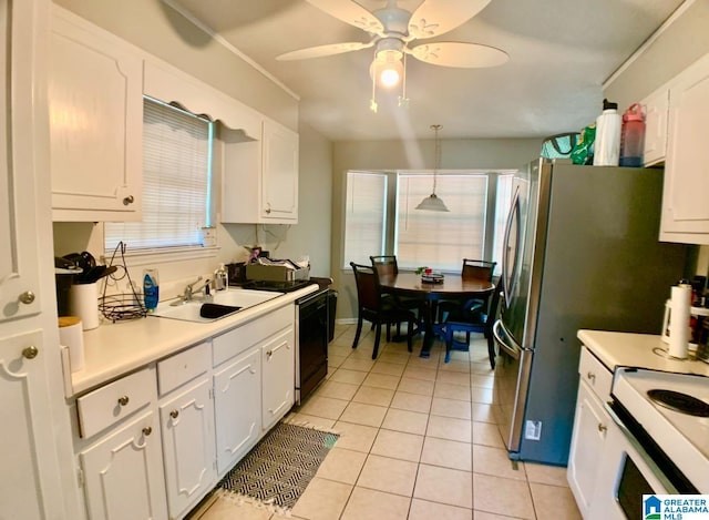 kitchen featuring sink, white cabinets, hanging light fixtures, and black dishwasher