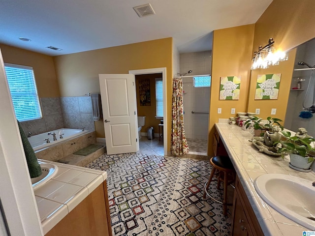 full bathroom featuring tile patterned flooring, vanity, independent shower and bath, and toilet