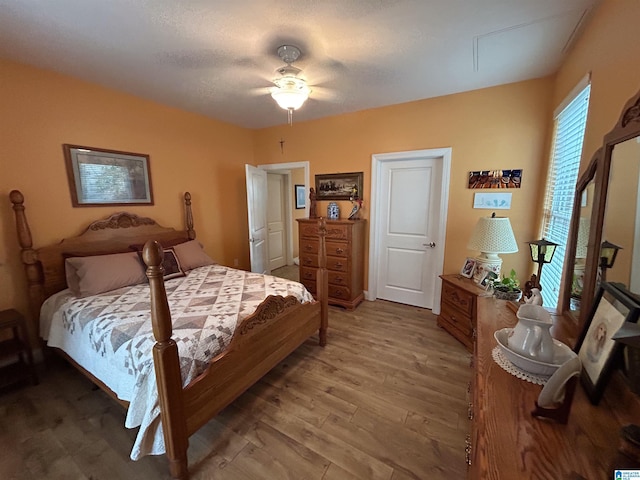 bedroom with hardwood / wood-style floors and ceiling fan